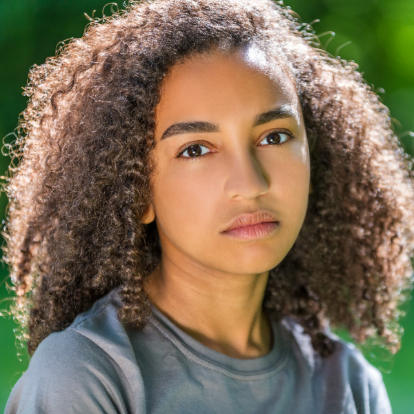 Young BIPOC teen staring blankly