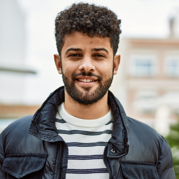 A close up of a person wearing a jacket smiling