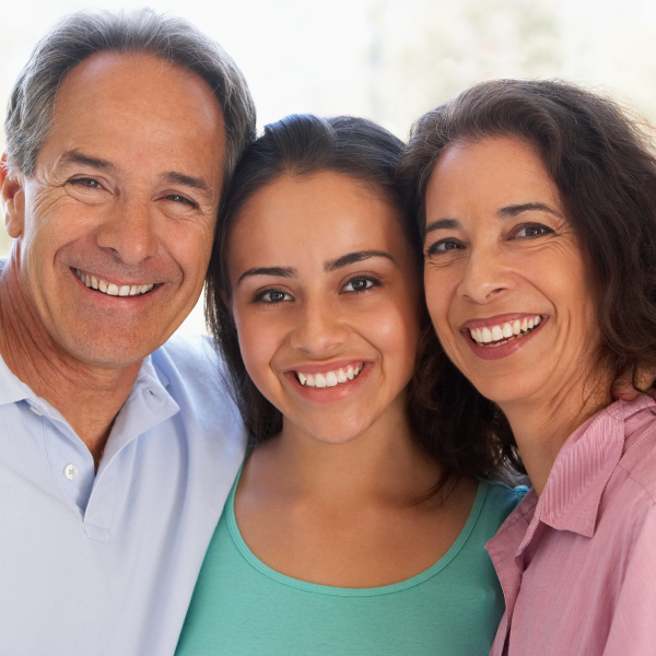 A happy family of three smiling