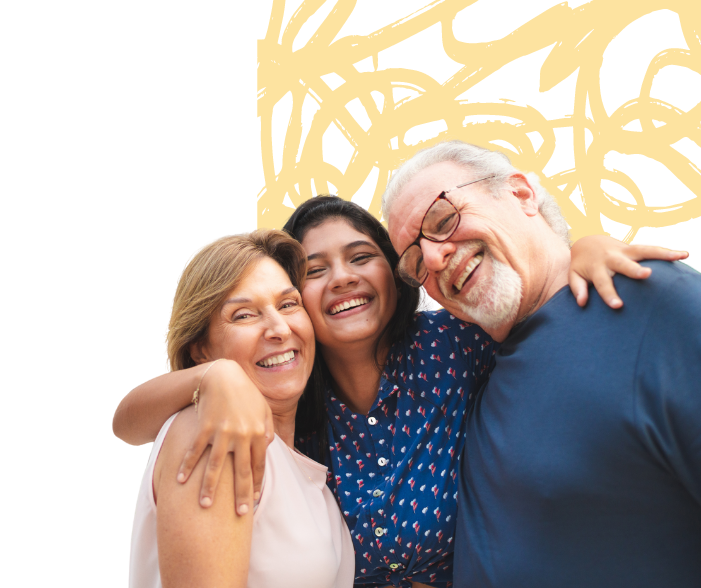 Grandparents with their grandchild between them, smiling at the camera.