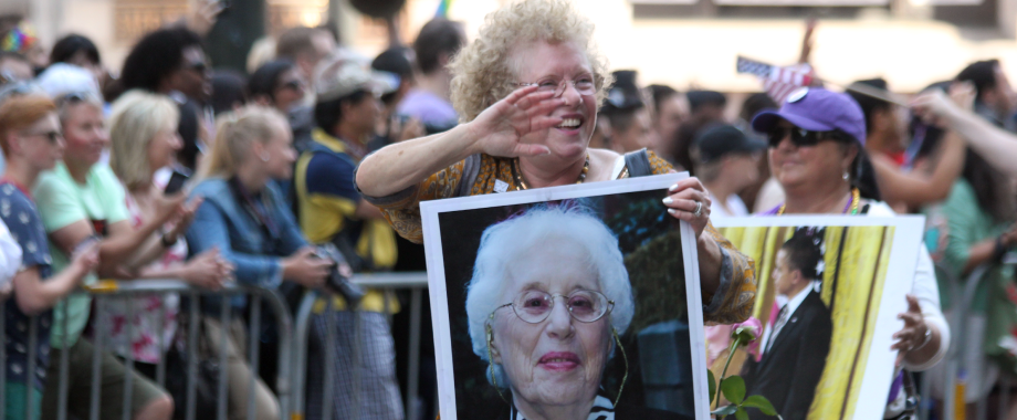 Suzanne Manford Swan marching with a photo of her mother